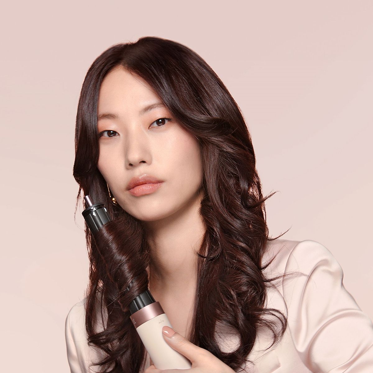Model styling hair with the Dyson Airwrap Co-anda2x